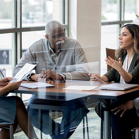 Mid adult woman and her family meet with lawyer