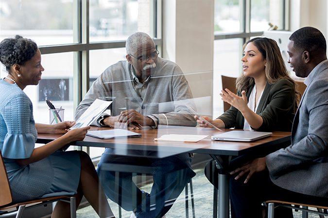 Mid adult woman and her family meet with lawyer