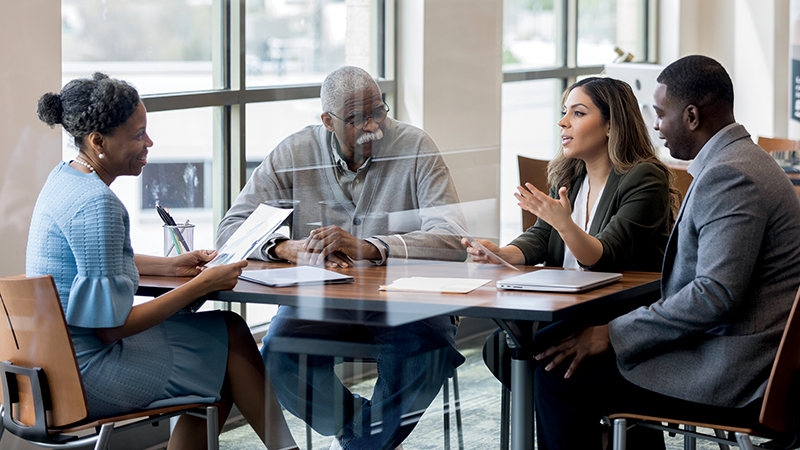 Mid adult woman and her family meet with lawyer